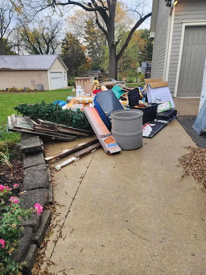 Dumpster being loaded with debris for 12 Yard Dumpster Rental in Vincennes